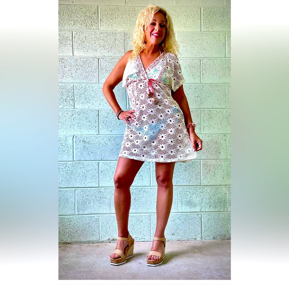 White stretch flower eyelet coverup w varnished shells on red ties.